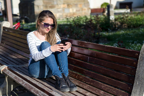 istock Young Girl With A Iphone. Chat by phone. New technologies. 1272569545