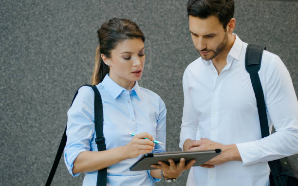 istock Two business people working together on a digital tablet outdoors 1272570549