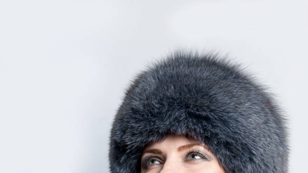 portrait of a woman in fur hat with grey smkey eyes makeup - thirty pieces of silver imagens e fotografias de stock