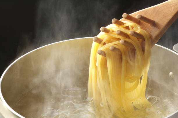 Close-up of boiled pasta Pasta, boil, steam, tongs, scoop, boiled, close-up, kitchen, lunch, spaghetti, hot water, copy space, pot, noodles boiled stock pictures, royalty-free photos & images