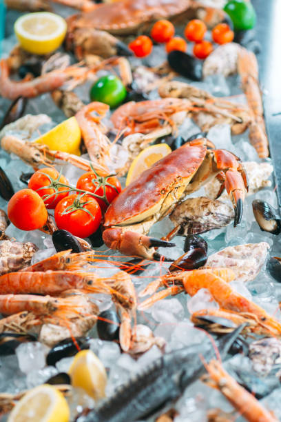 istock Seafood on ice. Crabs, sturgeon, shellfish, shrimp, Rapana, Dorado, on white ice. 1272572137