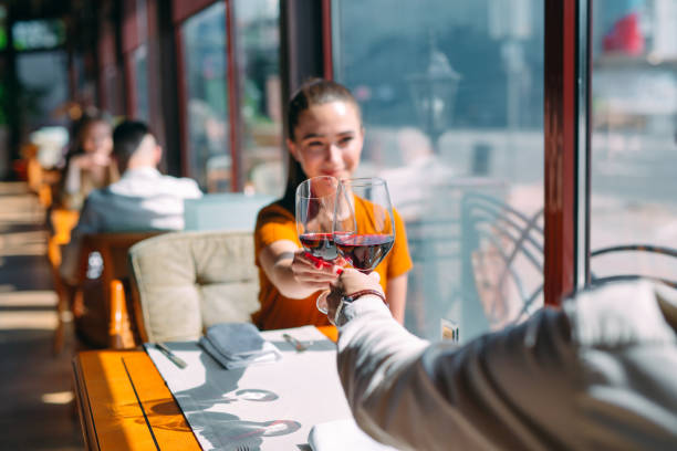 istock A young couple drinking wine in a restaurant near the window. 1272572233
