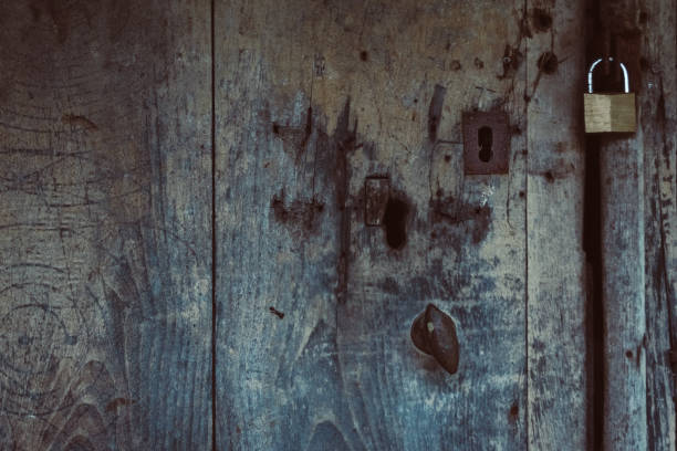 istock Old wooden door with rusty lock and padlock. 1272572478