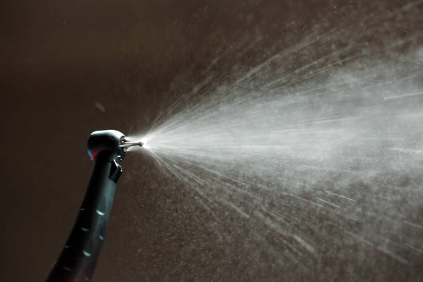 istock dental diamond cylinder bur with hand-piece and water spray. 1272573416