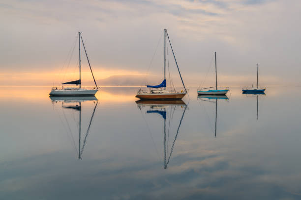 istock Misty Morning with Boats and Reflections on the Bay 1272573763