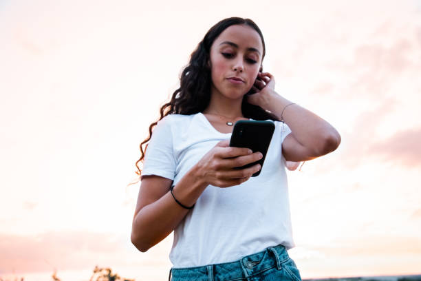 istock Young Woman Checking New Messages on her Smart Phone 1272574723