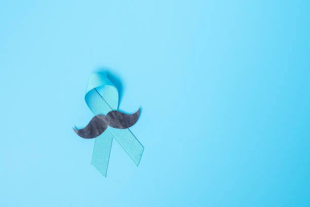 istock November Prostate Cancer Awareness month, light Blue Ribbon with mustache for supporting people living and illness. Healthcare, International men, Father and World cancer day concept 1272575672
