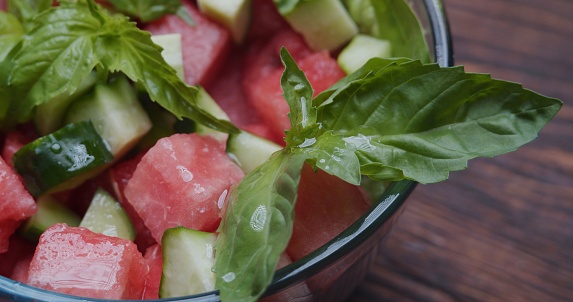 Fresh salad with watermelon, spinach, cucumber and basil