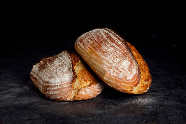 Two loaves of sourdough bread placed one on top of the other Two loaves of sourdough bread placed one on top of the other yeast starter stock pictures, royalty-free photos & images