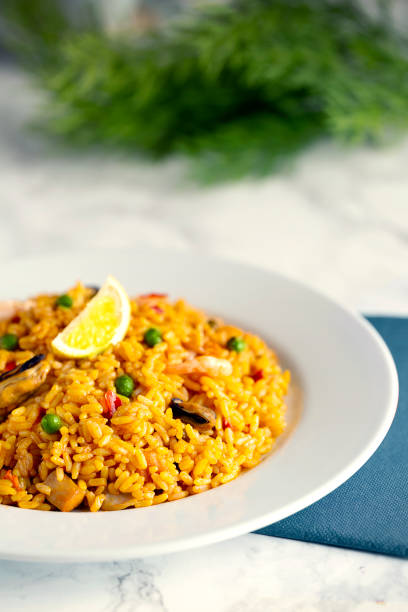 Spanish paella in the mediterranean coast - Made with shrimps, mussels, razor clams, clams and delicious bomb rice.