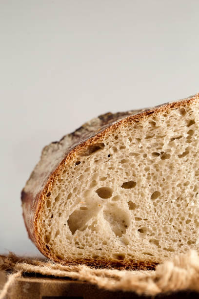 istock Detail of sourdough rustic bread cut in half 1272577737