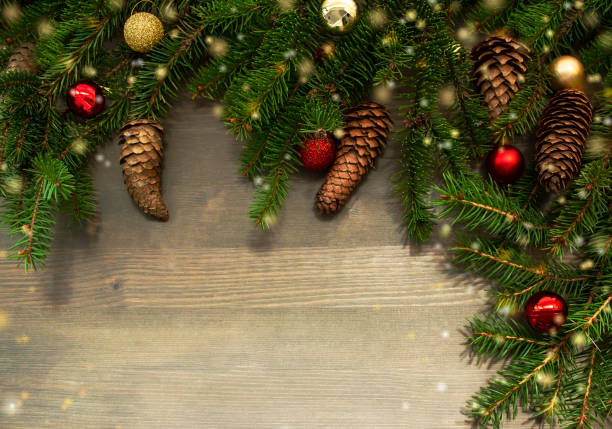 istock Fir branches on wooden background with New Year decorations, pine cones and bokeh light. Desing for Christmas banner or greeting card with space for text. 1272577831
