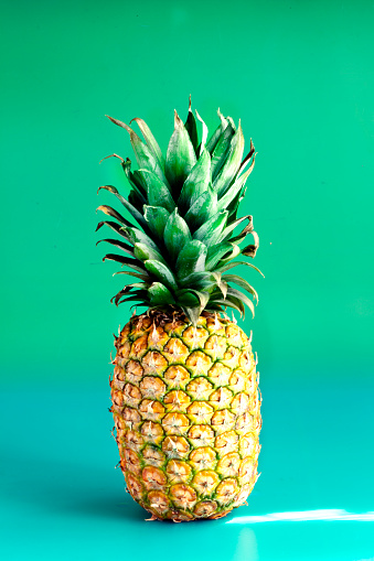 Pineapple isolated on turquoise background