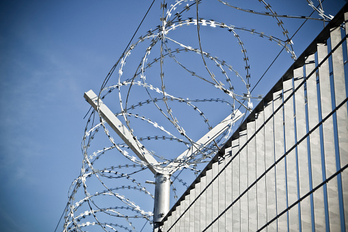 View of prison bars on foreground, background