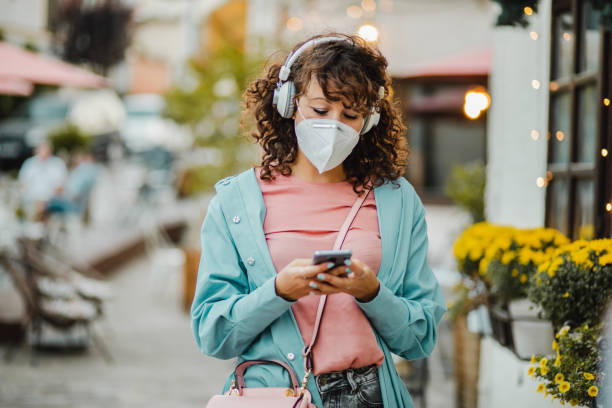istock Woman in the city with a protective mask 1272579007