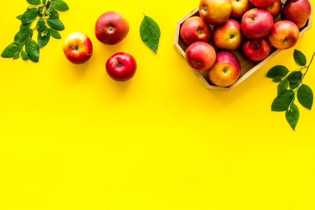 istock Frame of red apples with green leaves top view 1272579155
