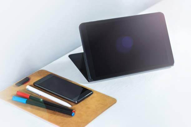 istock Workspace with a tablet, mobile phone and some markers and a pen to work from home or office 1272580510