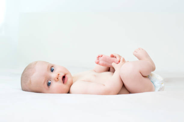 istock Cute baby girl lying on bed 1272580667