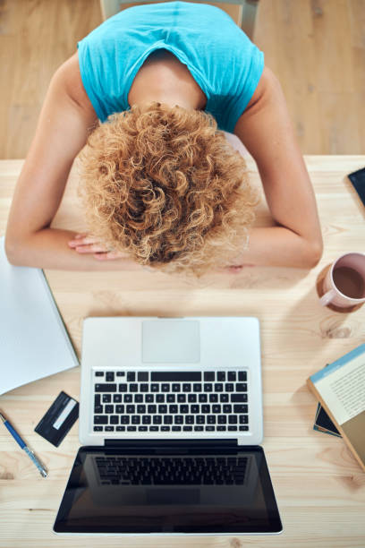 istock Woman sleeping on her desk at home while working remotely freelance job. Modern problems and issues with working from home. 1272582581
