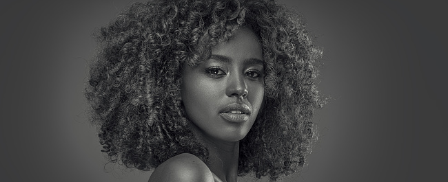Beauty portrait of woman with afro posing in studio.