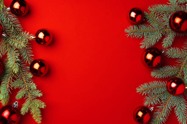 istock Christmas background with fir branches and balls on red 1272583946