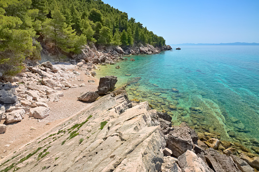 Empty beach and crystal clear water in the Adriatic Sea. South of Croatia - Peliesac peninsula. July 2020.
