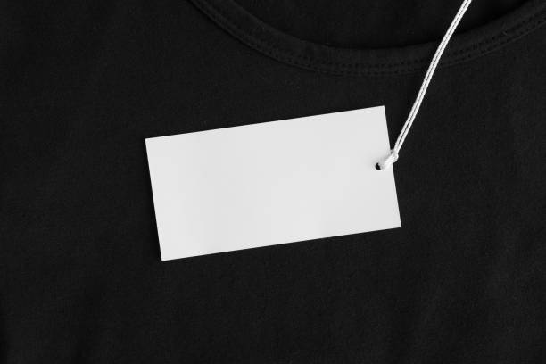 istock White clothing tag mockup on a black blouse. 1272585309