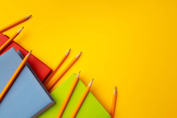 istock Notepad and color pencils on working space top view 1272586730