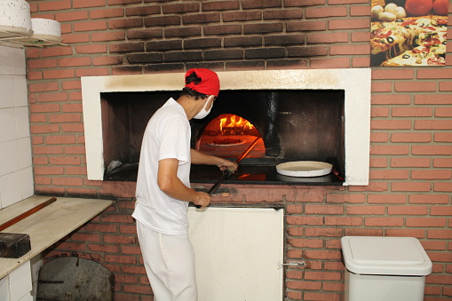 baking pizza in the wood oven