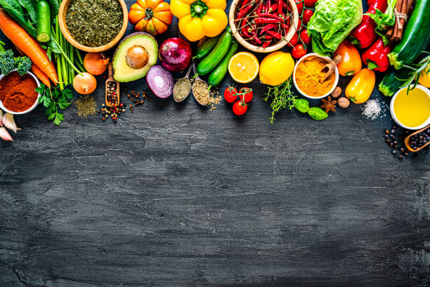 multi colored vegetables and spices frame on black slate background. overhead view - vegetables table imagens e fotografias de stock