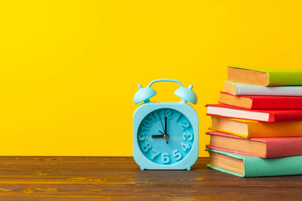 istock Books and alarm clock on table, education concept 1272587994