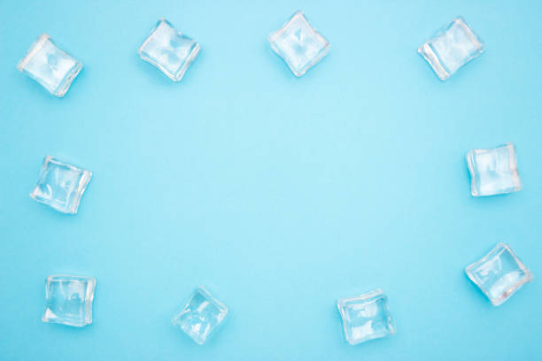 istock Ice cubes in the form of a frame on a blue background. Free space for text. Copyscape. 1272589244