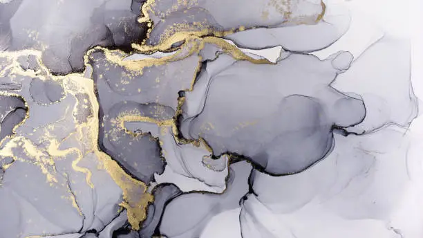 Photo of Black and golden abstract textured alcohol ink background.