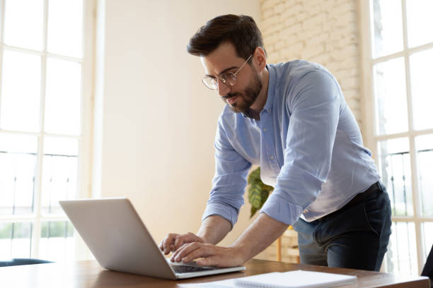 istock Serious Caucasian boss busy working typing on laptop 1272592617