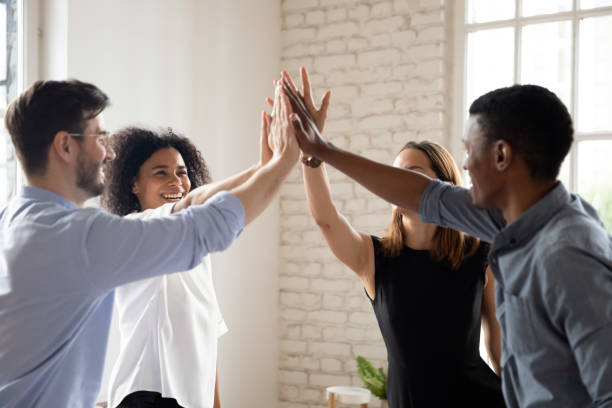 istock Excited multiethnic coworkers give high five engaged in teambuilding activity 1272592661