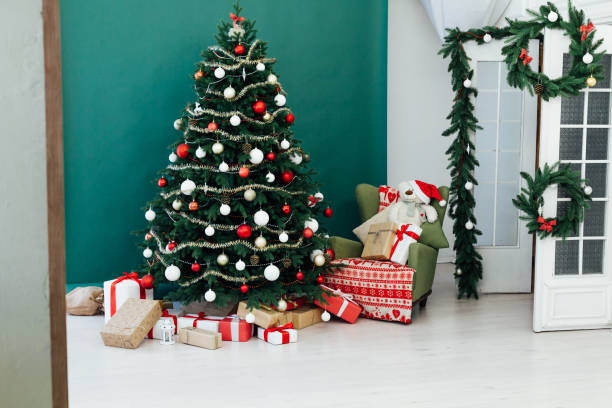 istock Rustic door opening into a room decorated for Christmas 1272592802