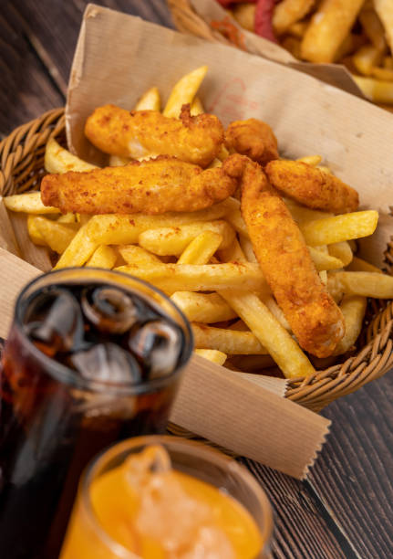 Spicy Chicken Fingers and French Fries with ice cola. Spicy Chicken Fingers and French Fries with ice cola chicken finger stock pictures, royalty-free photos & images
