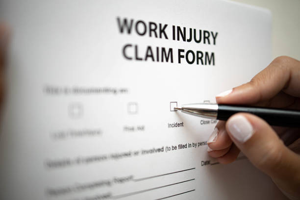 Filling Work Injury Claim Form stock photo