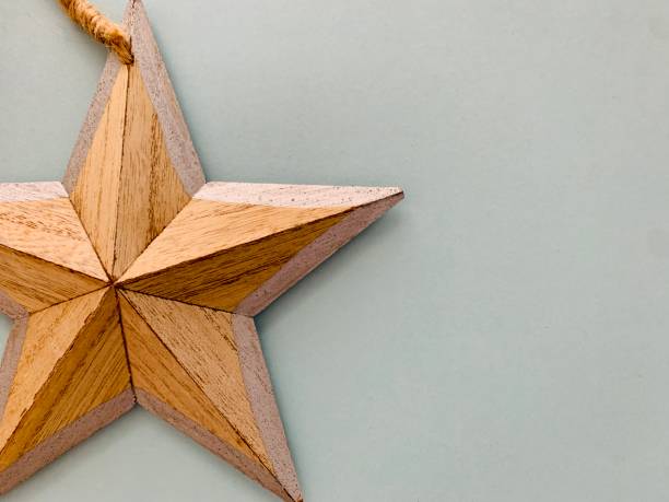 istock Wooden star on light blue background 1272596907