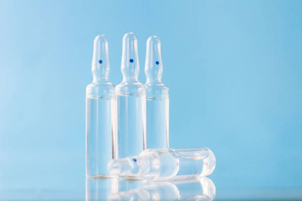 istock Medical ampoules on blue background. 1272597046