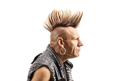 Profile shot of a middle aged punker with a mohawk isolated on white background