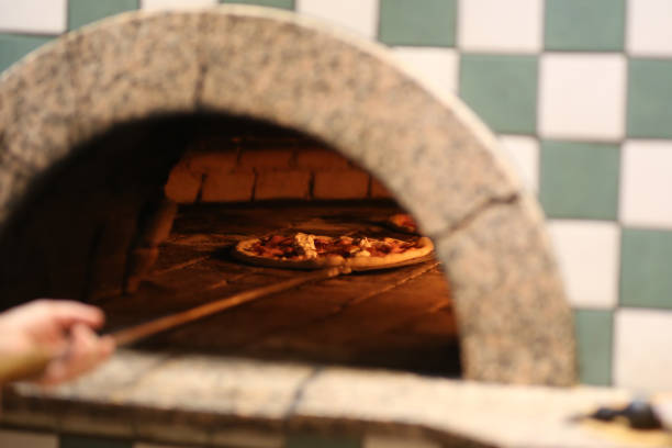 istock Italian pizza is cooked in a wood-fired oven 1272599433