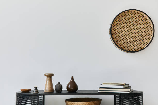 istock Stylish scandinavian home interior with design wooden commode, books, decorations, copy space and elegant personal accessories in modern home decor. Template. 1272599598