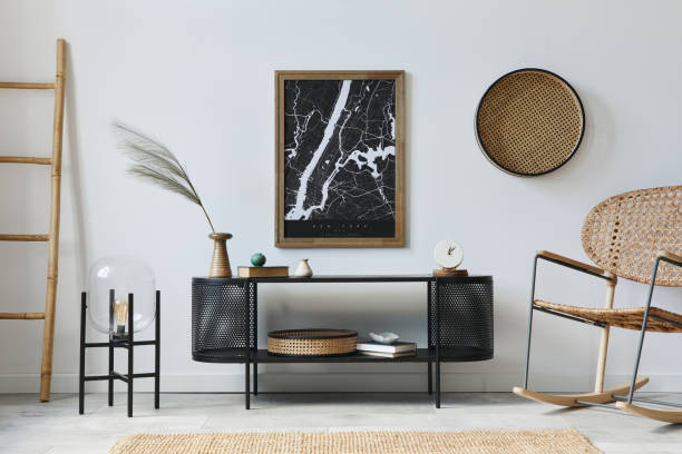 istock Modern scandinavian living room interior with mock up poster frame, design commode, plants, rattan armchair, book and elegant accessories in stylish home decor. Template. 1272599656