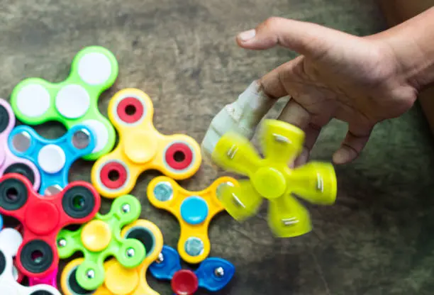 Photo of Yellow spinners spin on hands.