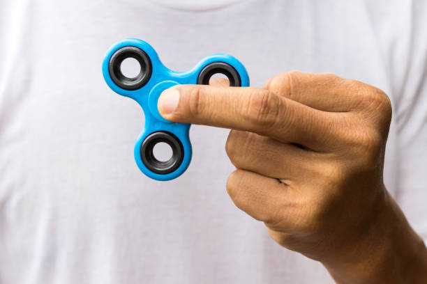 istock Close-up of a spinner in fingers. 1272599901