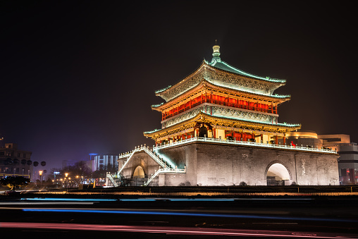 Xian Bell Tower illuminated at night in Xian, Shaanxi, China, The tower was constructed in 1384 and is the largest and best preserved bell tower of its kind in China. It is considered a symbol of the city and is situated in the center of the city. It houses several large bronze bells.