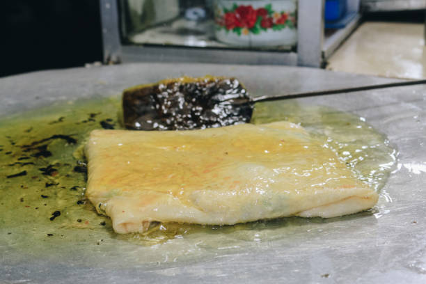 istock Martabak Telor or omelette martabak. Savoury pan-fried pastry stuffed with egg, meat and spices. Traditional food snacks from Indonesia. 1272602774