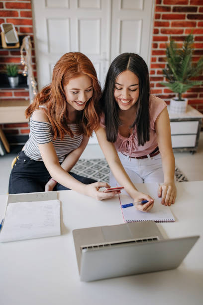 istock Friends looking at a laptop 1272602823