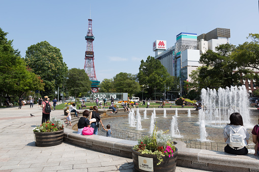 People at the Odori Park in Sapporo, Hokkaido, Japan. Throughout the year, many events are held in the Odori Park. The Sapporo TV Tower have an observation deck, souvenir shop and restaurant. It is a famous tourist attraction in Sapporo.